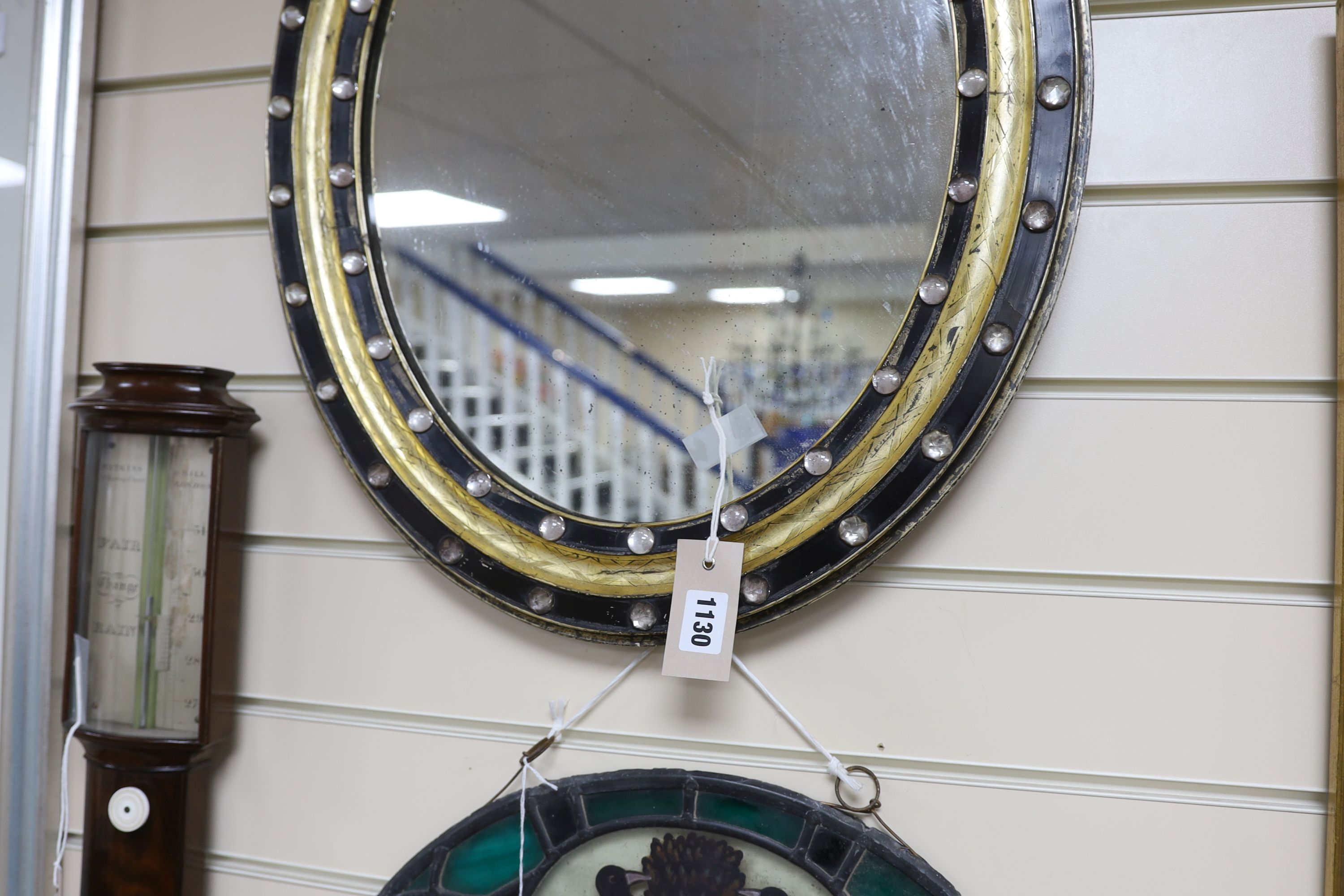 A small 19th century Irish oval wall mirror, with twin faceted and cabochon glass border, width 46cm, height 56cm